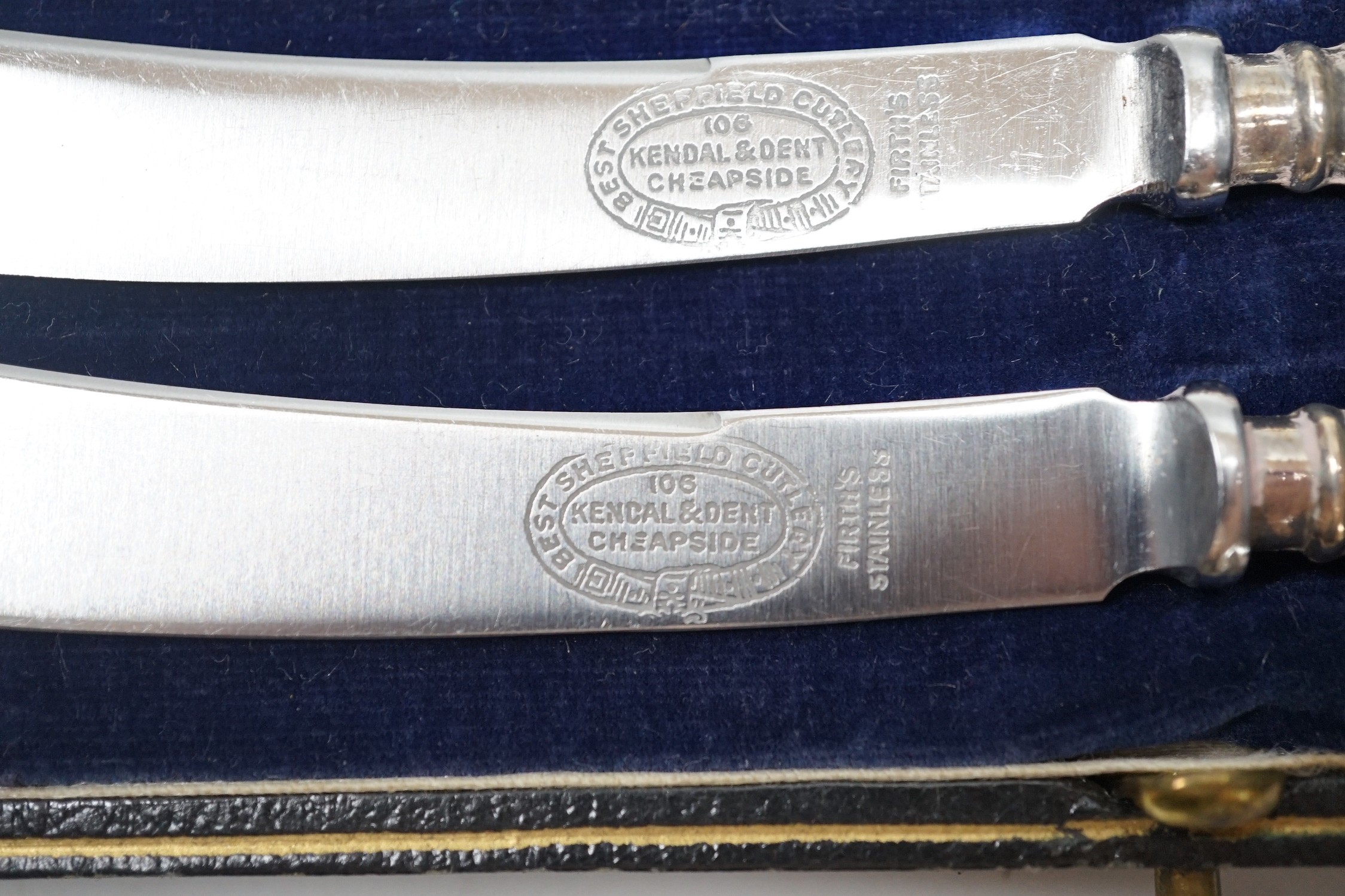 A set of six tea knives, an Edwardian silver butter shell and knife and a set of six silver coffee spoons, all cased.